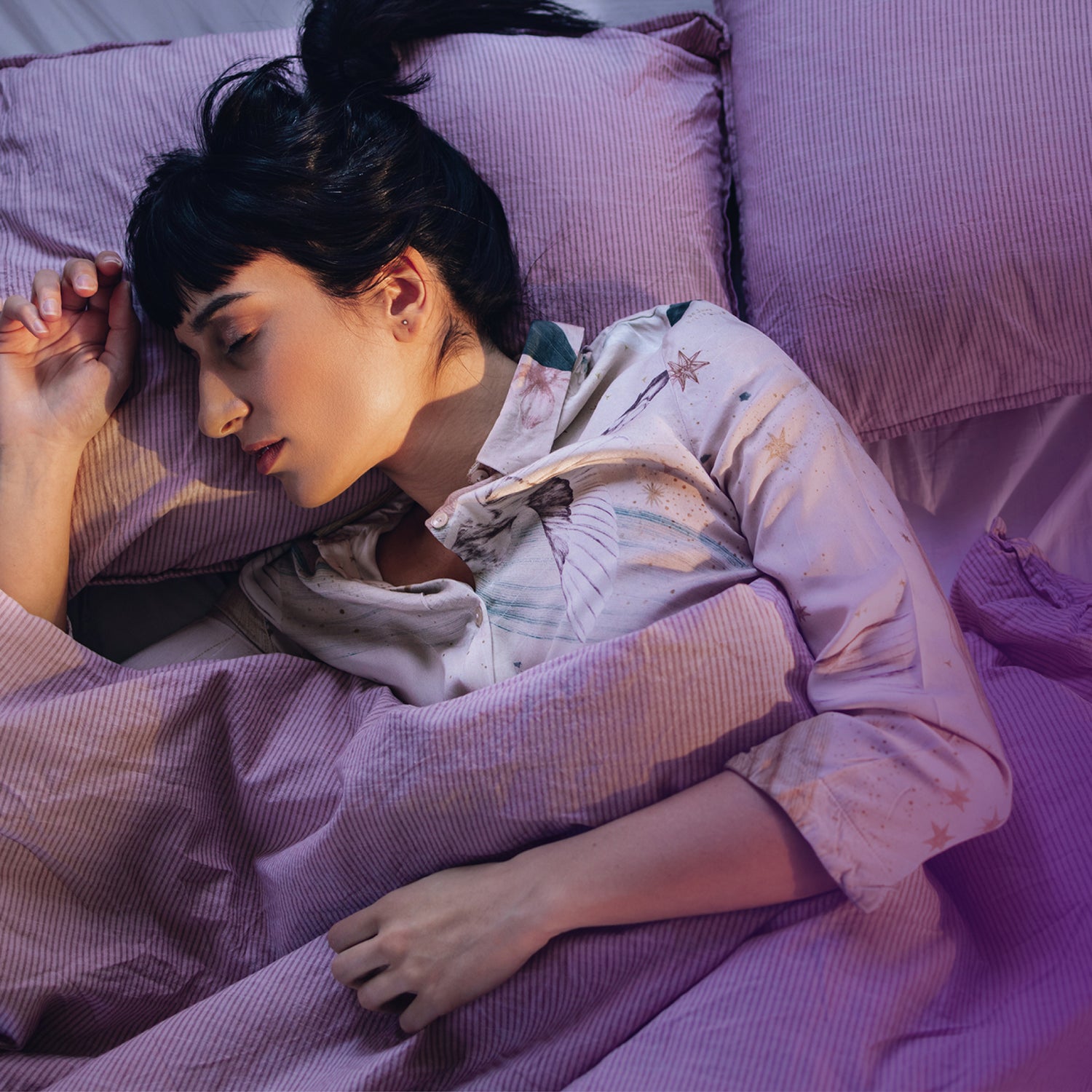 Eine Frau liegt schlafend in ihrem Bett